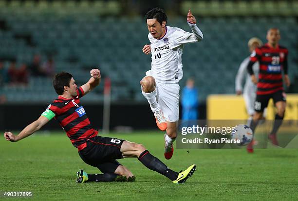 Yojiro Takahagi of Sanfrecce Hiroshima is tackled by Michael Beauchamp of the Wanderers during the AFC Asian Champions League match between the...