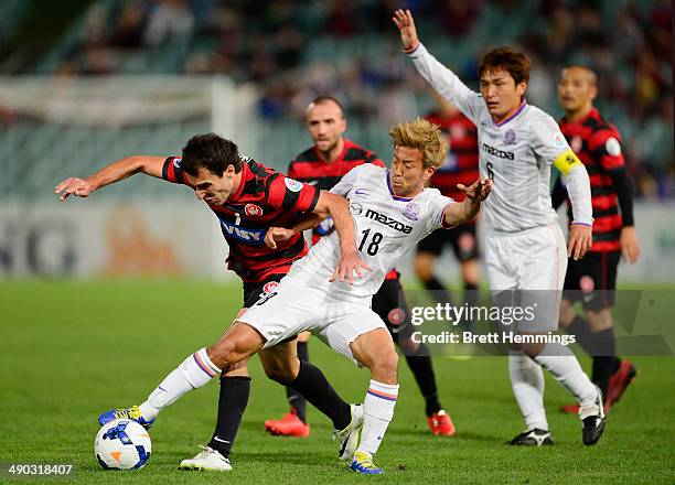 Yoshifumi Kashiwa of Sanfrecce Hiroshima is tackled by Labinot Haliti of the Wanderers during the AFC Asian Champions League match between the...