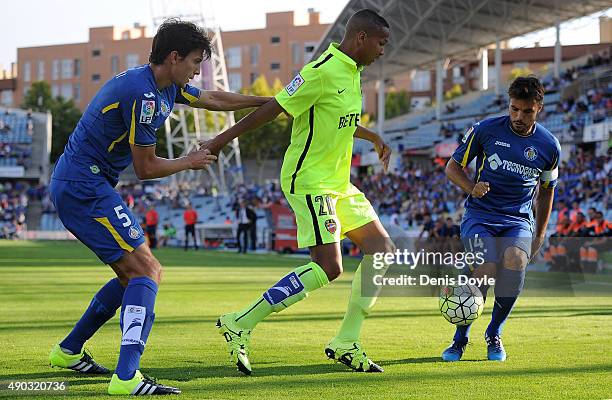 Deyverson of Levante is tackled by Santiago Vergini and Pedro Leon of Getafe during the La liga match between Getafe and Levante at estadio Coliseum...