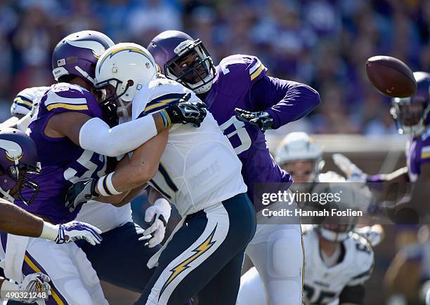 Anthony Barr and Sharrif Floyd of the Minnesota Vikings force a fumble by Philip Rivers of the San Diego Chargers during the first quarter of the...