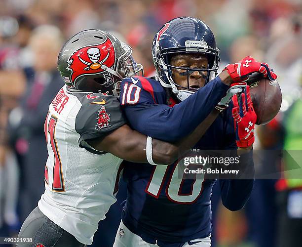 DeAndre Hopkins of the Houston Texans can't hold on to the pass as he is defended by Alterraun Verner of the Tampa Bay Buccaneers in the second...