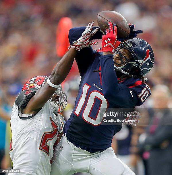 DeAndre Hopkins of the Houston Texans can't hold on to the pass as he is defended by Alterraun Verner of the Tampa Bay Buccaneers in the second...