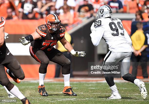 Joe Thomas of the Cleveland Browns blocks Aldon Smith of the Oakland Raiders during the third quarter at FirstEnergy Stadium on September 27, 2015 in...