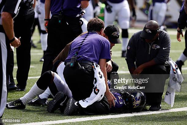 Free safety Kendrick Lewis of the Baltimore Ravens is examined on the field in the second quarter of a game against the Cincinnati Bengals at M&T...