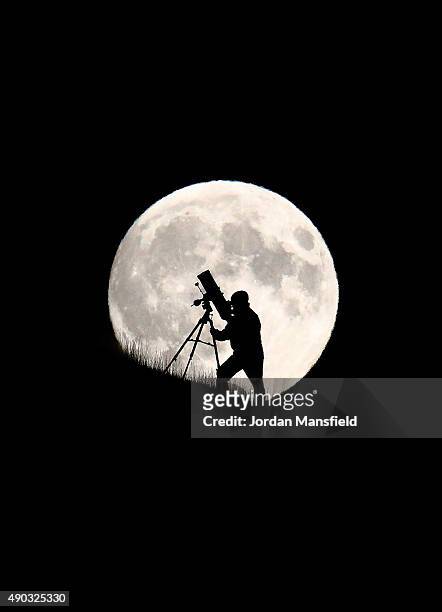 An astronomer stargazes ahead of tonight's supermoon on September 27, 2015 in Brighton, England. Tonight's supermoon, so called because it is the...