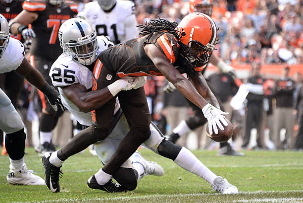 Travis Benjamin of the Cleveland Browns dives for a touchdown while being tackled by DJ Hayden of the Oakland Raiders during the fourth quarter in…