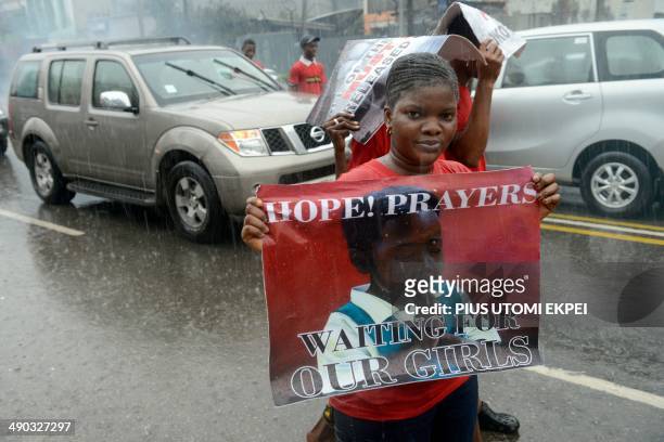 Women carring placards in support of schoolgirls kidnapped by Boko Haram attend a street demonstration in Lagos on May 14, 2014 to mark the one-month...
