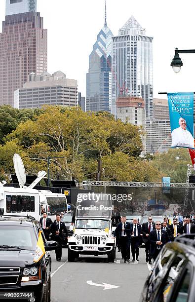 Pope Francis waves to the crowd from the Popemobile during a parade September 27, 2015 in Philadelphia, Pennsylvania. Pope Francis is in Philadelphia...