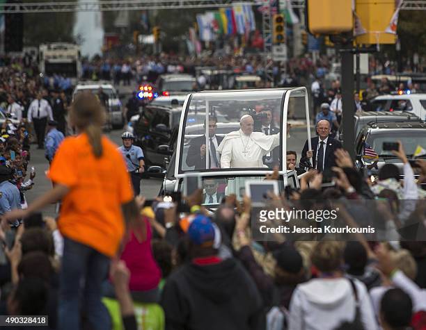 Pope Francis rides to mass in the Popemobile along Benjamin Franklin Parkway on September 27, 2015 in Philadelphia. This is the Pope's final day of a...
