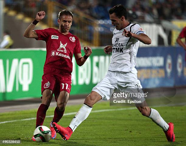 Marko Devic of FC Rubin Kazan is challenged by Pablo Fontanello of FC Ural Sverdlovsk Oblast during the Russian Premier League match between FC Rubin...
