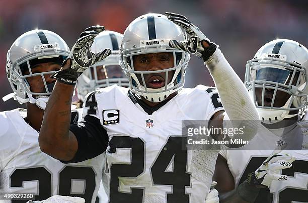 Charles Woodson of the Oakland Raiders celebrates after intercepting a pass during the fourth quarter against the Cleveland Browns at FirstEnergy...
