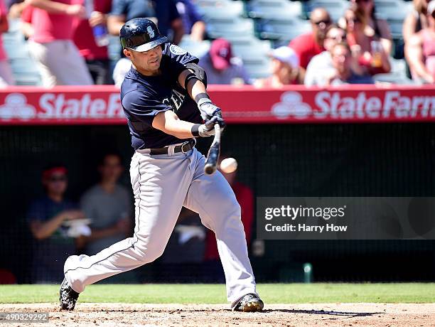 Jesus Montero of the Seattle Mariners singles to score Nelson Cruz for a 1-0 lead over the Los Angeles Angels during the fourth inning at Angel...