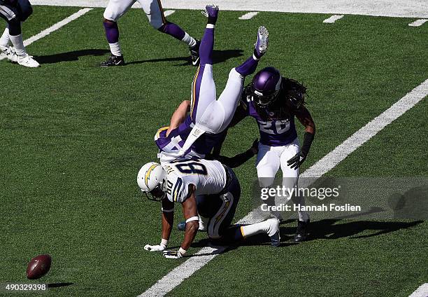 Captain Munnerlyn of the Minnesota Vikings flips over Malcom Floyd of the San Diego Chargers after a missed reception as Trae Waynes of the Minnesota...