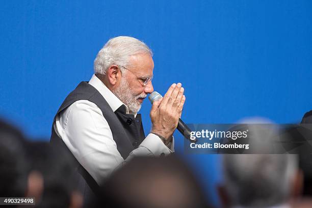 Narendra Modi, India's prime minister, gestures after speaking with Mark Zuckerberg, chief executive officer of Facebook Inc., during a town hall...