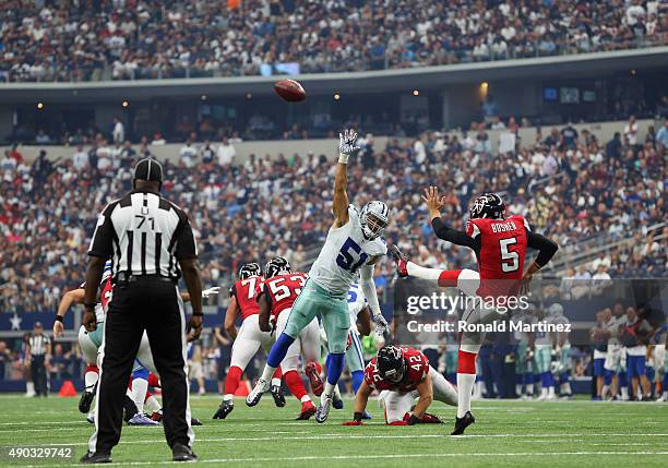 Matt Bosher of the Atlanta Falcons punts the ball over Kyle Wilber of the Dallas Cowboys at AT&T Stadium on September 27, 2015 in Arlington, Texas.