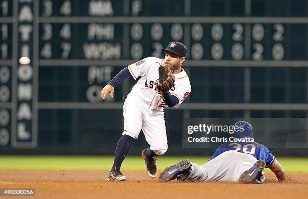 Jose Altuve of the Houston Astros waits for the throw as Will Venable of the Texas Rangers steals second base at Minute Maid Park on September 27,...