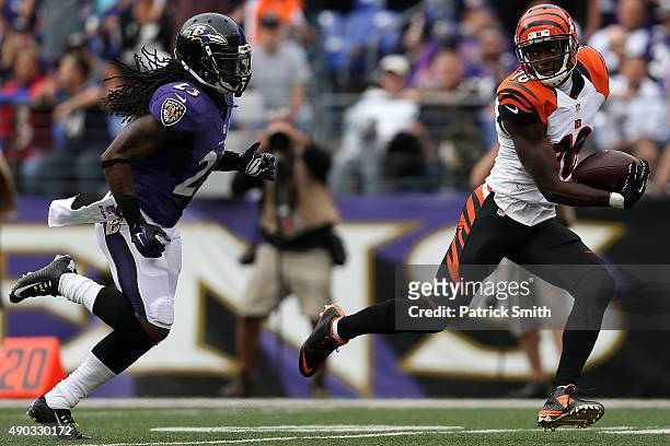 Wide receiver A.J. Green of the Cincinnati Bengals scores a fourth quarter touchdown past free safety Kendrick Lewis of the Baltimore Ravens during a...