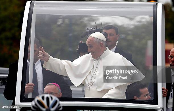 Pope Francis waves to the crowd from the Popemobile during a parade September 27, 2015 in Philadelphia, Pennsylvania. Pope Francis is in Philadelphia...