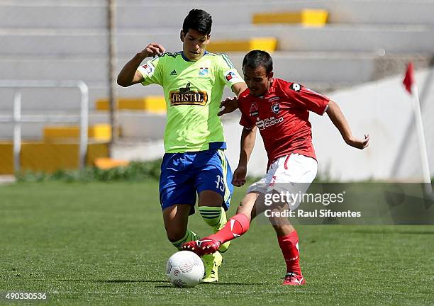 Alexis Cossio of Sporting Cristal vies for the ball with Mario Tajima of Cienciano during a match between Cienciano and Sporting Cristal as part of...