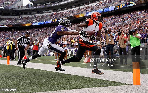 Wide receiver A.J. Green of the Cincinnati Bengals catches a fourth quarter touchdown pass in front of cornerback Jimmy Smith of the Baltimore Ravens...