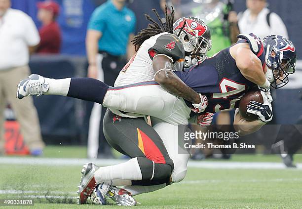 Jay Prosch of the Houston Texans is tackled by D.J. Swearinger of the Tampa Bay Buccaneers in the fourth quarter on September 27, 2015 at NRG Stadium...