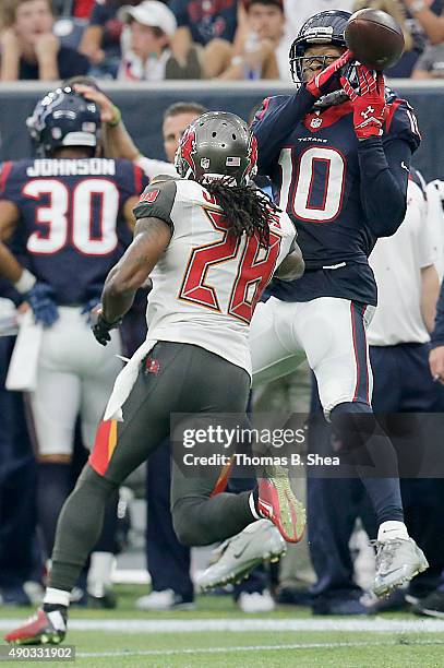 DeAndre Hopkins of the Houston Texans drops a ball while being covered by Tim Jennings of the Tampa Bay Buccaneers in the third quarter on September...