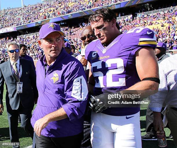 Head coach Mike Zimmer and Chad Greenway of the Minnesota Vikings walk onto the field after defeating the San Diego Chargers 31-14 at TCF Bank...