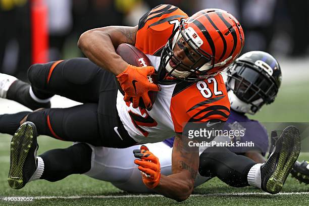 Wide receiver Marvin Jones of the Cincinnati Bengals catches a pass in front of defensive back Kyle Arrington of the Baltimore Ravens in the fourth...