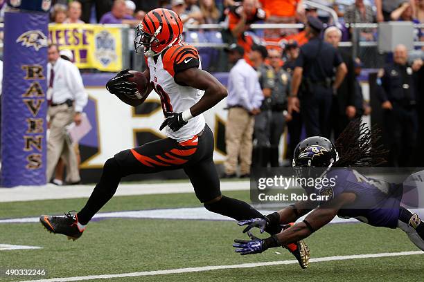 Wide receiver A.J. Green of the Cincinnati Bengals scores a fourth quarter touchdown past free safety Kendrick Lewis of the Baltimore Ravens during a...