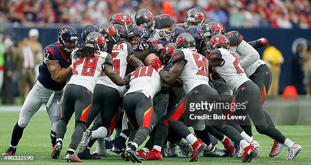 Jay Prosch of the Houston Texans is tackled amongst a pile of Tampa Bay Buccaneers defensive players in the fourth quarter at NRG Stadium on...