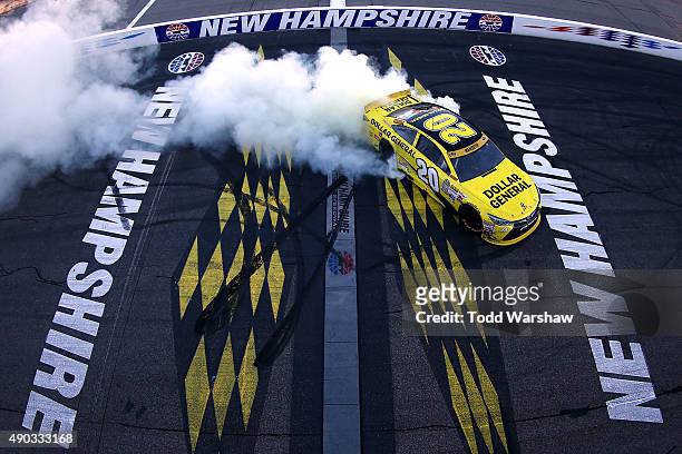 Matt Kenseth, driver of the Dollar General Toyota, celebrates with a burnout after winning the NASCAR Sprint Cup Series SYLVANIA 300 at New Hampshire...