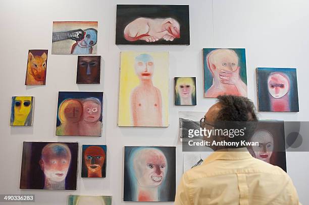Visitor looks at artworks by Miriam Cahn on May 14, 2014 at the Hong Kong Convention and Exhibition Centre in Wan Chai, Hong Kong. VIP and media were...