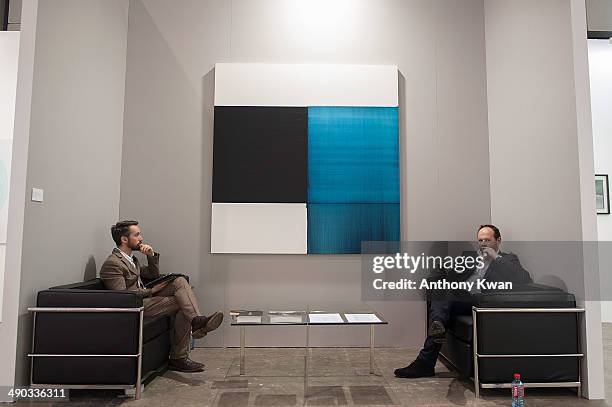 Exhibitors are seen at the Art Basel Exhibition on May 14, 2014 at the Hong Kong Convention and Exhibition Centre in Wan Chai, Hong Kong. VIP and...