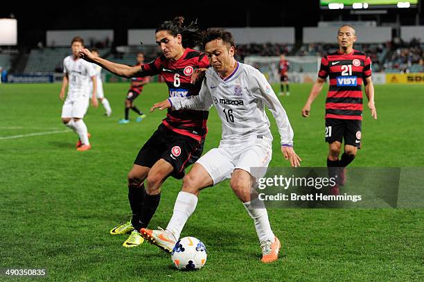 Jerome Polenz of the Wanderers and Satoru Yamagishi of Sanfrecce Hiroshima contest the ball during the AFC Asian Champions League match between the...