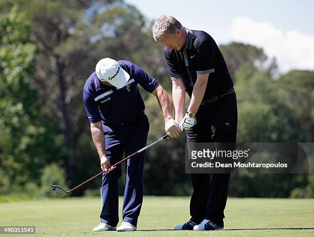 Paul McGinley of Ireland gives swing advice or tips to Former Manchester United Manager, David Moyes during the Open de Espana ProAm at PGA Catalunya...