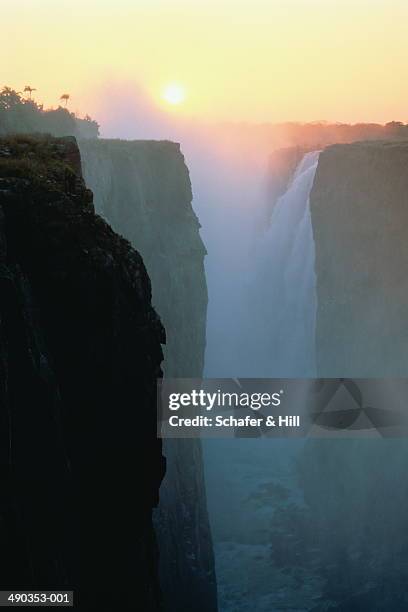 victoria falls at sunset,zimbabwe - victoria falls sunset stock pictures, royalty-free photos & images