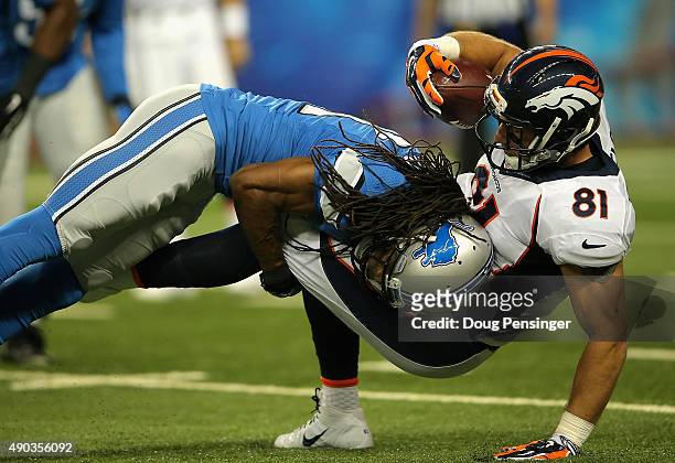 Rashean Mathis of the Detroit Lions tackles Owen Daniels of the Denver Broncos in the first quarter at Ford Field on September 27, 2014 in Detroit,...