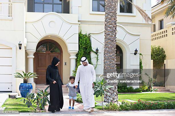 arab family walking outdoors on a sunny day - arab home stock pictures, royalty-free photos & images