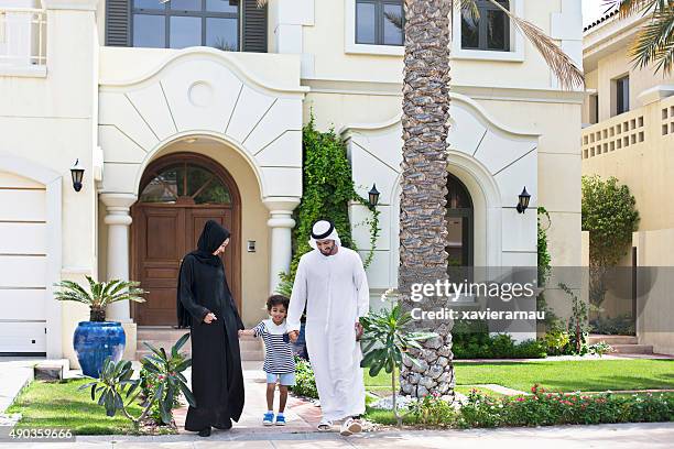 arab family walking outdoors on a sunny day - dubai boy stock pictures, royalty-free photos & images