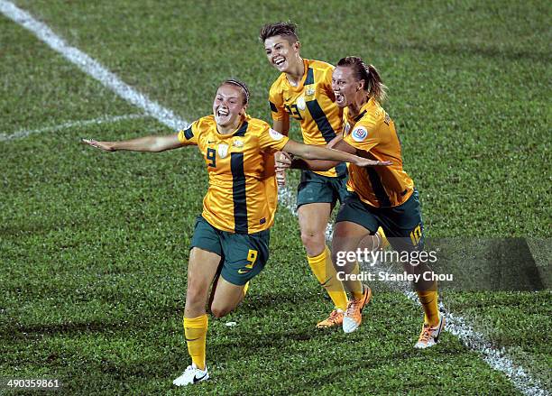 Caitlin Foord of Australia celebrates with her team-mates after scoring against Japan during the AFC Women's Asian Cup Group B match between...