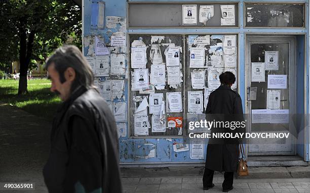 Woman looks at obituary notices on the former State Lottery office walls of the village of Rasovo, some 150 km north from Bulgarian capital Sofia on...