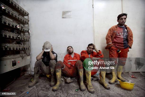 Exhausted miners rest as they await their trapped friends on May 14, 2014 in Soma, Turkey. Rescuers pulled more dead and injured from the coal mine...