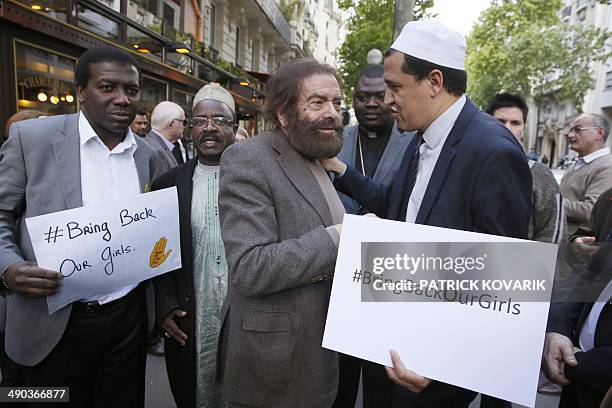French Jewish writer Marek Halter , Imam Hassen Chalghoumi , and other people take part in a protest against the kidnapping by Nigerian Islamist...
