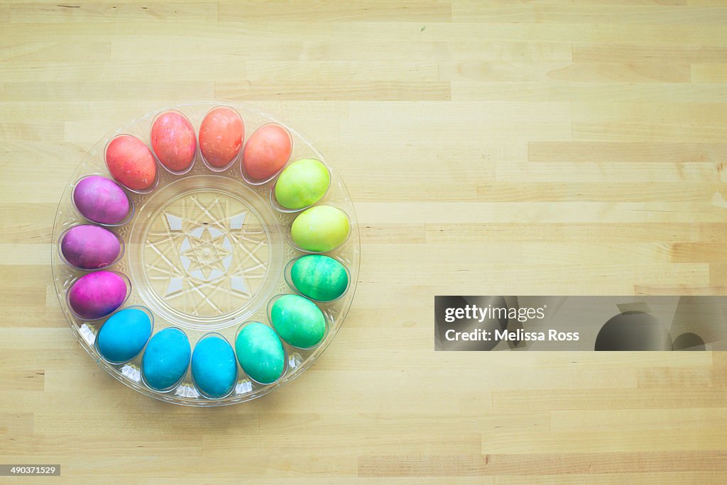 Circular plate filled with dyed Easter eggs