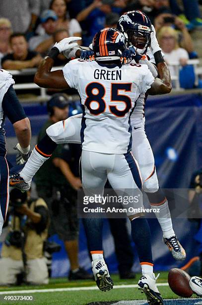 Ronnie Hillman of the Denver Broncos celebreats his 7-0 touchdown run with teammate Virgil Green against the Detroit Lions during the first half of...