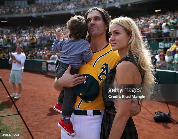 Barry Zito of the Oakland Athletics stands on the field with his son Marsden Zito and wife Amber Zito before the game against the San Francisco...