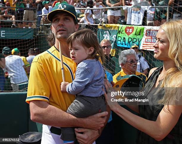 Barry Zito of the Oakland Athletics stands on the field with his son Marsden Zito and wife Amber Zito before the game against the San Francisco...