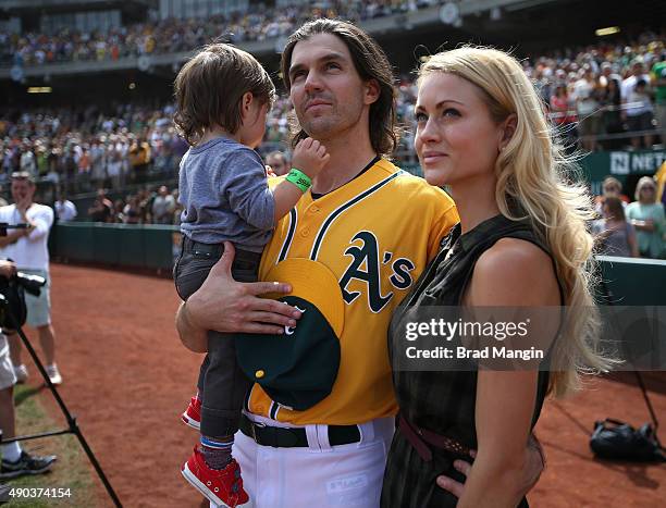 Barry Zito of the Oakland Athletics stands on the field with his son Marsden Zito and wife Amber Zito before the game against the San Francisco...