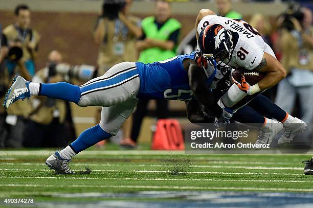 Stephen Tulloch of the Detroit Lions tackles Owen Daniels of the Denver Broncos during the first half of play at Ford Field. The Detroit Lions hosted...