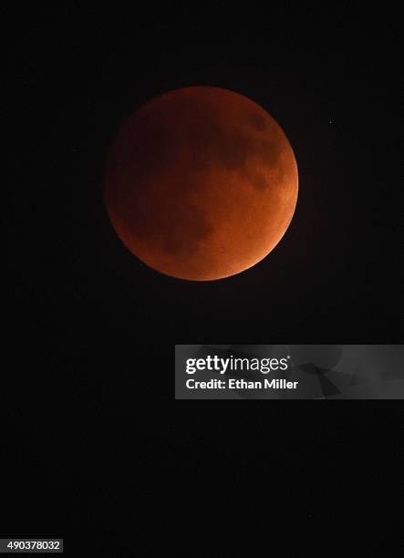 An eclipsed supermoon is shown on September 27, 2015 in Las Vegas, Nevada. A supermoon occurs when a full moon coincides with its perigee, which is...